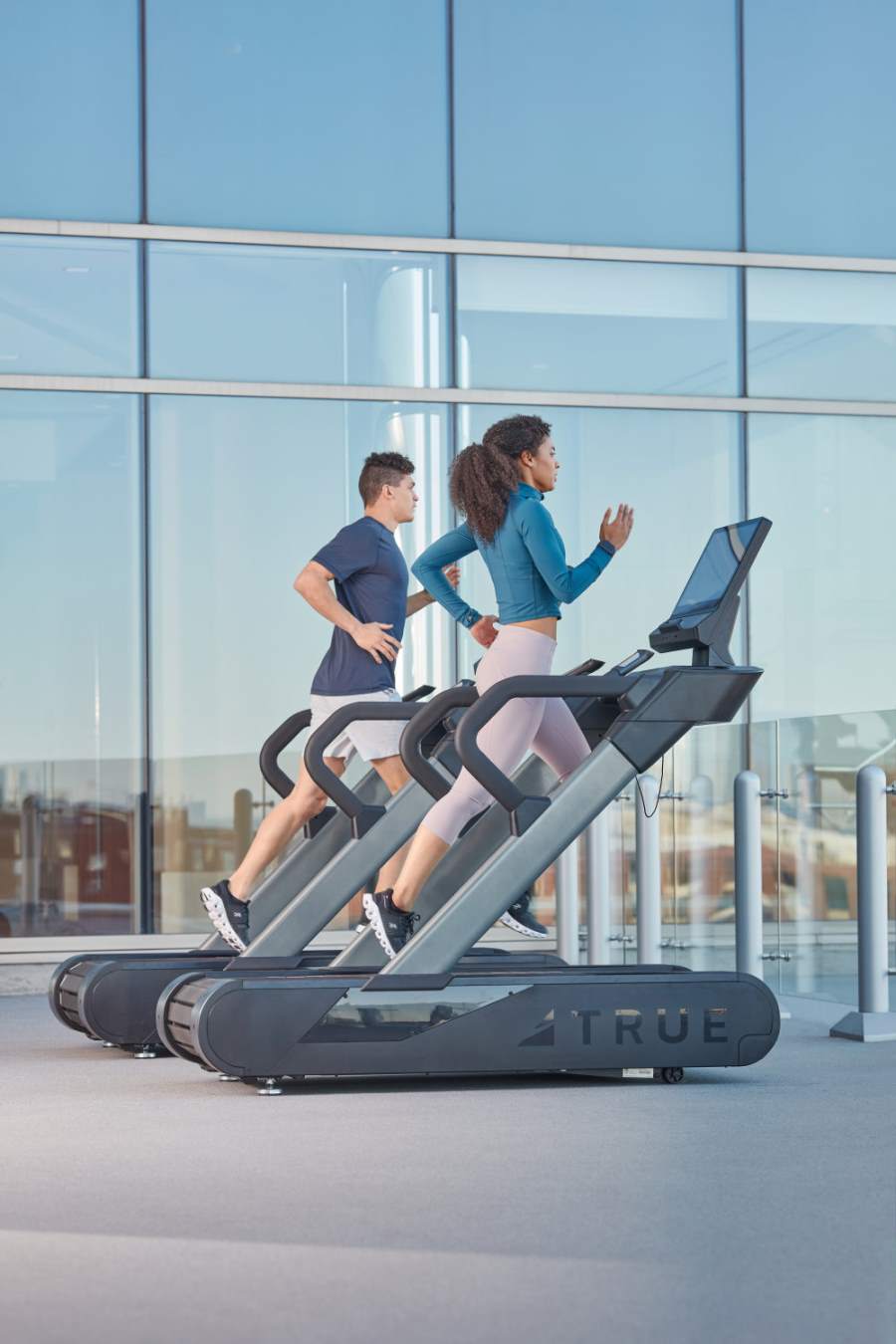 man and woman jogging on treadmill