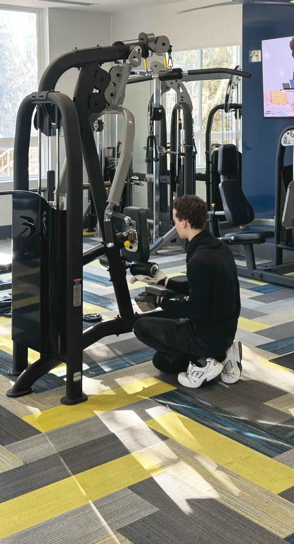 Technician repairing fitness equipment